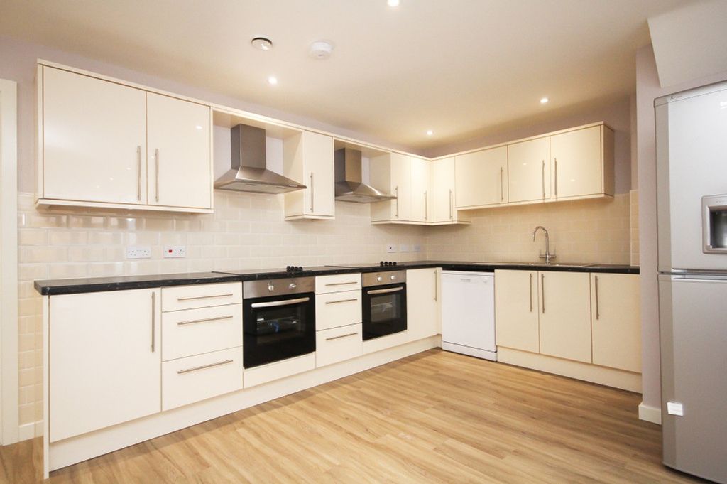 Property photo 2 of 5 A Spacious And Modern Kitchen, Featuring Sleek Cab...