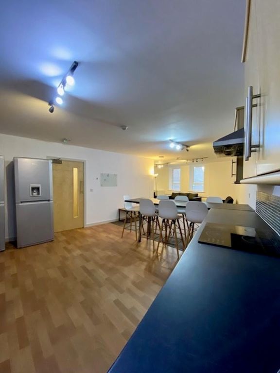 Property photo 3 of 9 A Modern Kitchen Featuring A Large Dining Table Wi...