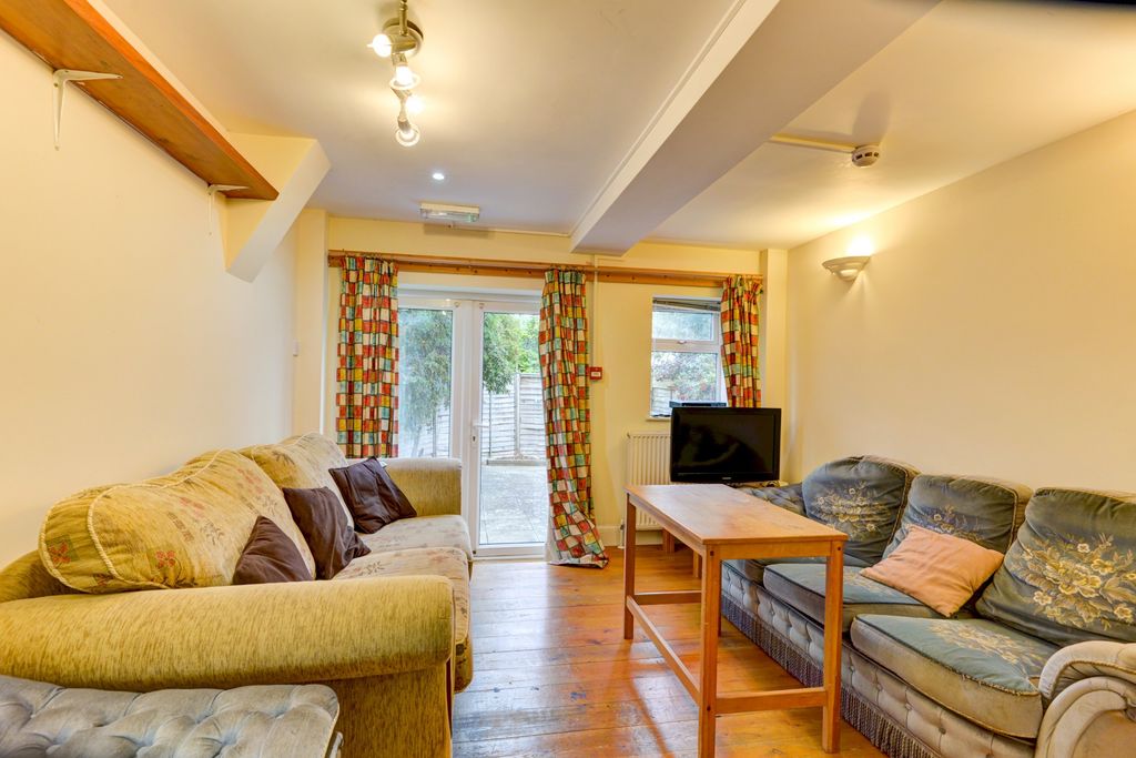 Property photo 3 of 18 A Bright And Inviting Living Room Featuring A Comf...