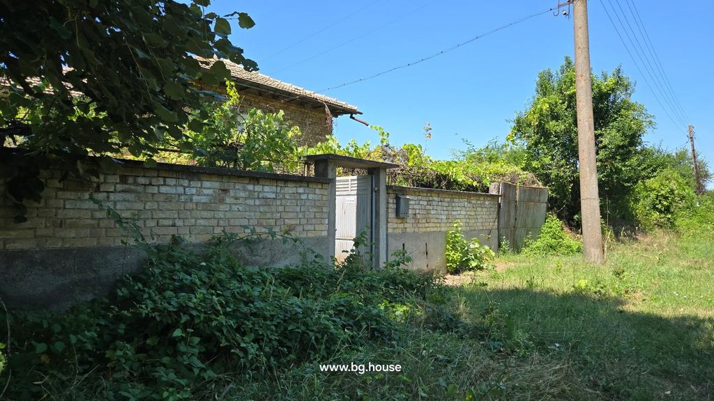 Property photo 2 of 67 Brick Wall With Metal Gate And Green Vines, Utility Pole And Grassy Area Beside The Wall Under Clear Blue Sky