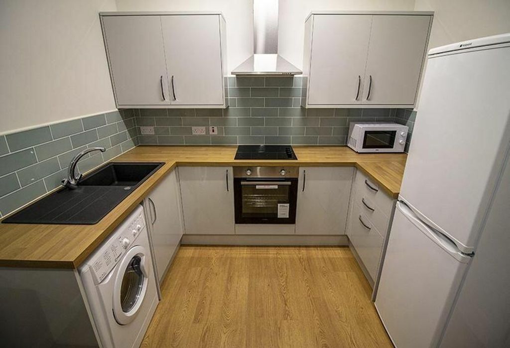 Property photo 3 of 6 Modern Kitchen Featuring Sleek Cabinetry, A Stylis...