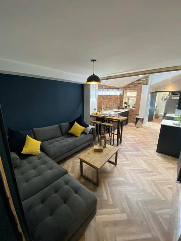 Property photo 1 of 6 Modern And Inviting Living Room Featuring Stylish ...