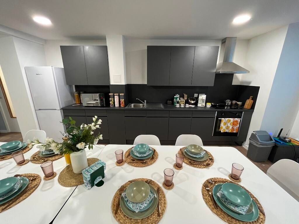 Property photo 3 of 15 A Modern And Stylish Kitchen Featuring Sleek Black...