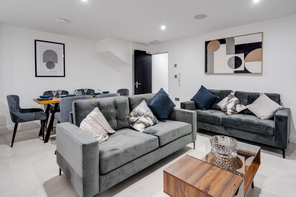 Property photo 3 of 12 Bright And Spacious Living Room Featuring Comforta...