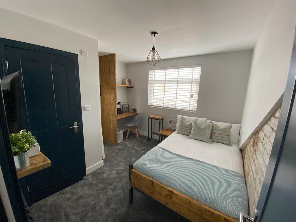Property photo 2 of 6 A Modern, Well-Lit Bedroom Featuring A Comfortable...