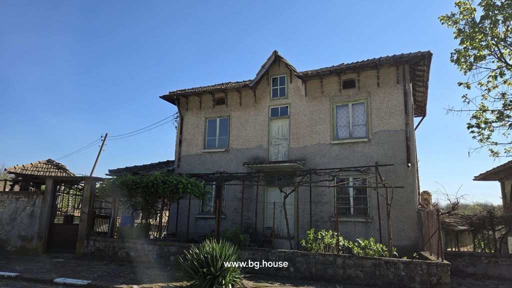 Property photo 1 of 37 Front View Of A Two-Storey Bulgarian House With Textured Walls And Several Windows.