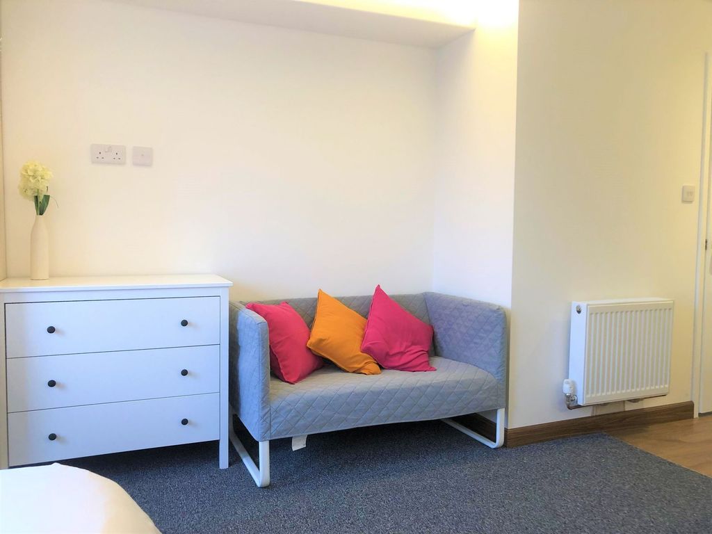 Property photo 3 of 7 A Cozy Living Room Corner Featuring A Modern Grey ...