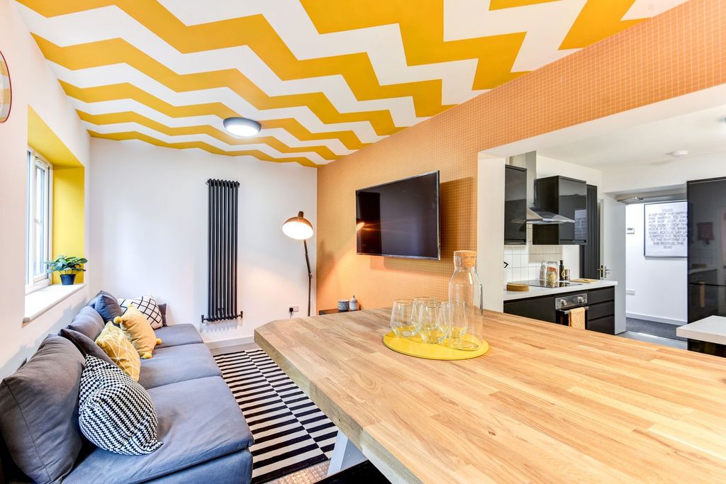 Property photo 2 of 5 This Vibrant Living Room Features A Stylish Design...