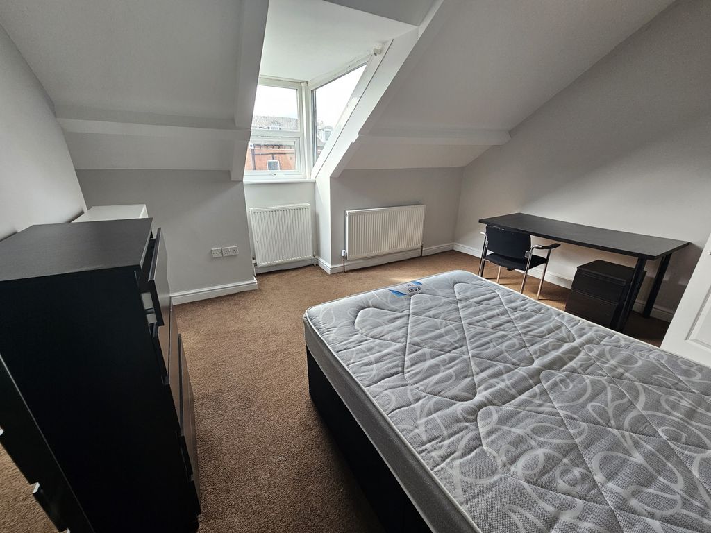 Property photo 2 of 15 A Neatly Maintained Bedroom With Ample Natural Lig...