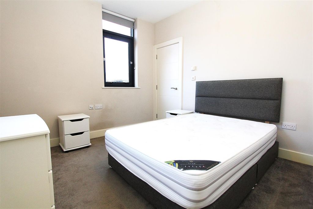 Property photo 2 of 8 Modern Bedroom With Plush Bed And Sleek Storage...
