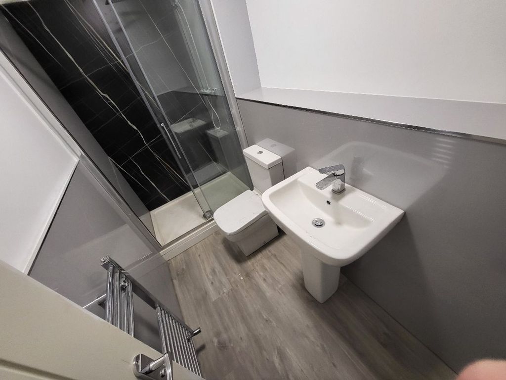 Property photo 1 of 11 A Modern Bathroom Featuring A Sleek Design With A ...
