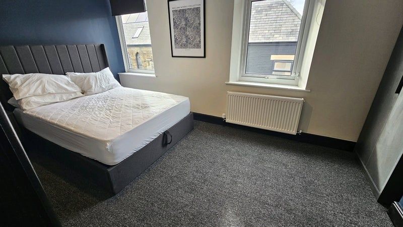 Property photo 3 of 8 A Neat And Tidy Bedroom Featuring A Large Bed With...