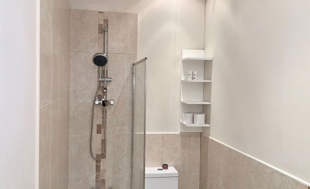 Property photo 2 of 14 A Modern Bathroom Featuring A Walk-In Shower With ...