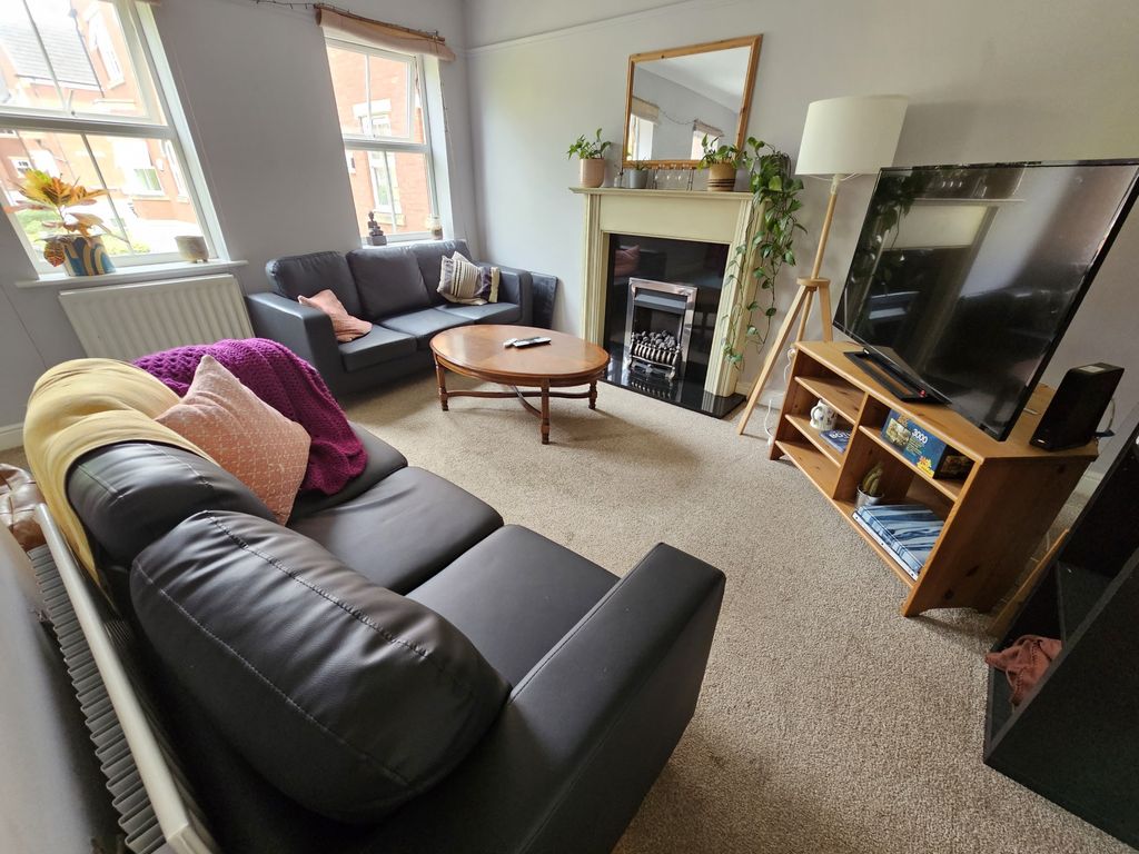 Property photo 1 of 18 A Bright And Inviting Living Room Featuring Comfor...