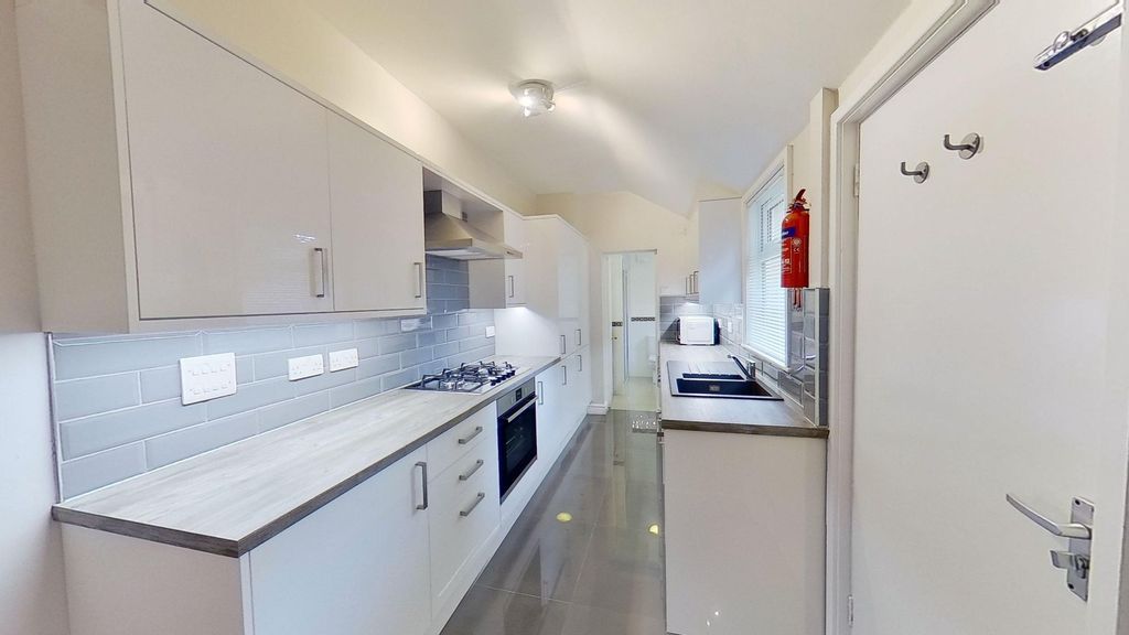 Property photo 2 of 9 Bright Modern Galley Kitchen With Glossy Tiled Flo...