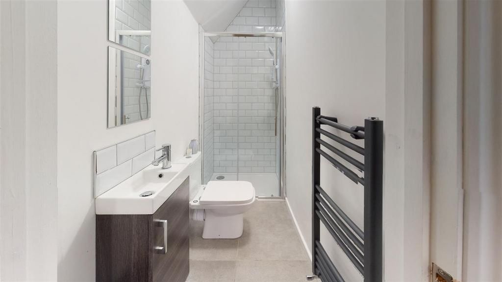 Property photo 2 of 13 A Modern And Clean Bathroom Featuring Stylish Fixt...