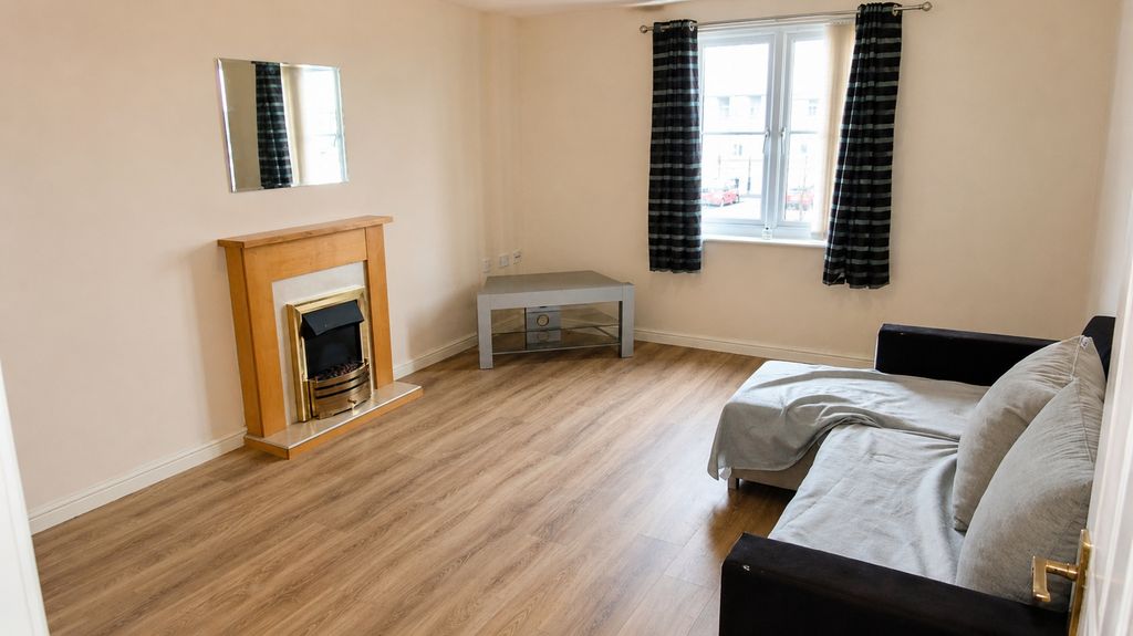 Property photo 3 of 8 Bright Living Area With Modern Wood-Style Floor...