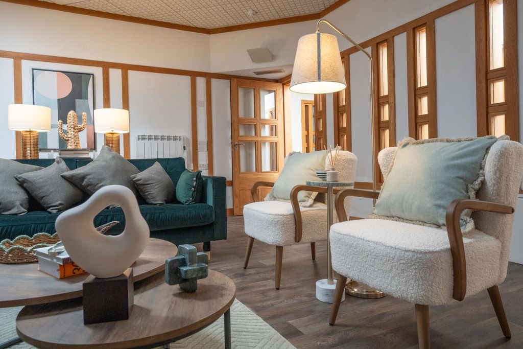Property photo 1 of 13 A Stylish And Inviting Living Room Featuring A Dee...