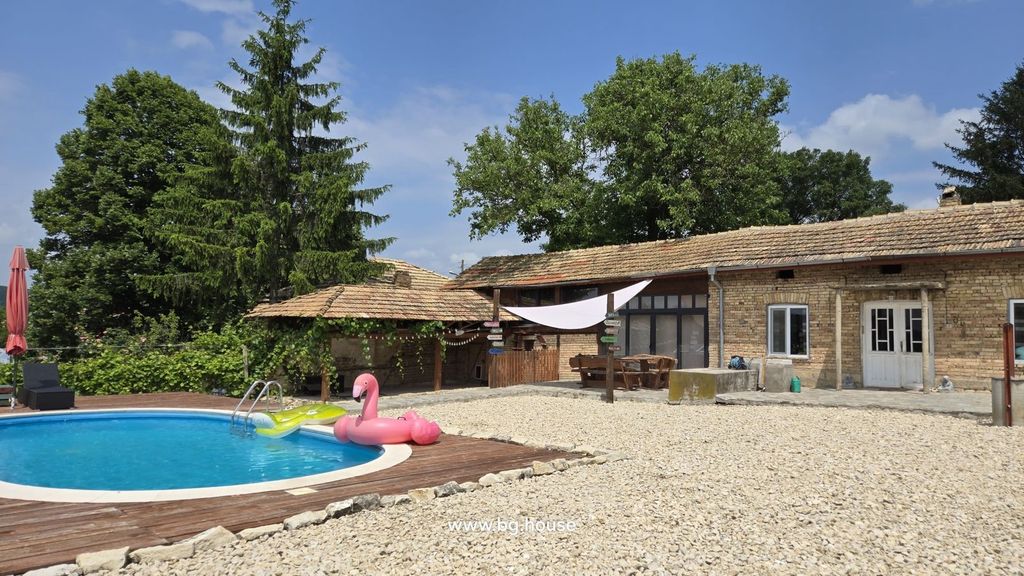 Property photo 2 of 100 View Of The House Exterior Featuring A Round Swimming Pool With Inflatables And A Shaded Seating Area Beside The House.