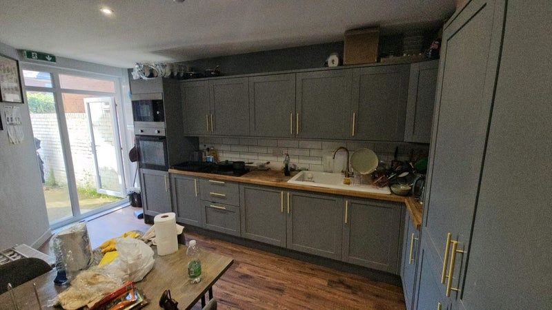 Property photo 3 of 9 Modern Kitchen Featuring Stylish Grey Cabinetry Wi...