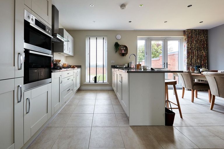 Property 2 of 10. Modern Kitchen With Ample Storage Space And Sociable Breakfast Bar