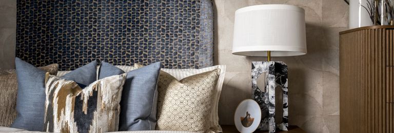 Property 3 of 5. Closeup View Of Bedside Decorated In Royal Blue And Beige Tones.