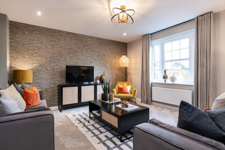 Property 3 of 10. A Modern Living Room With Plush Grey Sofas And A Textured Accent Wall In The Foreground