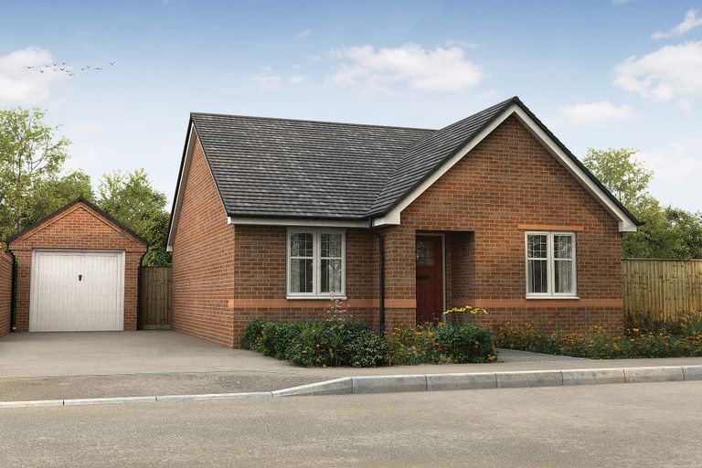 Property 1 of 4. A Brick Bungalow With A Detached Garage Sits On A Paved Driveway In Front Of A Wooded Area Under A c