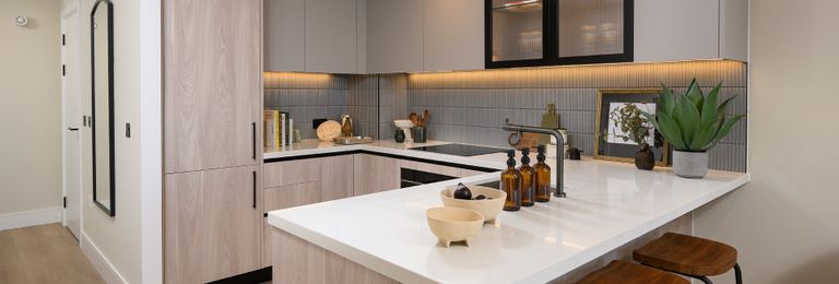 Property 2 of 6. Kitchenette With Attached Breakfast Island, Beige Surfaces And White Countertops
