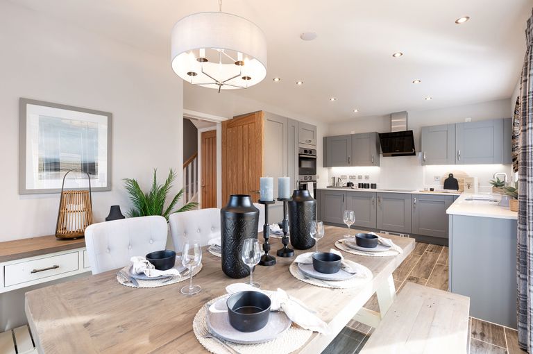 Property 2 of 10. A Modern And Stylish Kitchen With A Dining Area, Featuring Gray Cabinets, Wooden Countertops