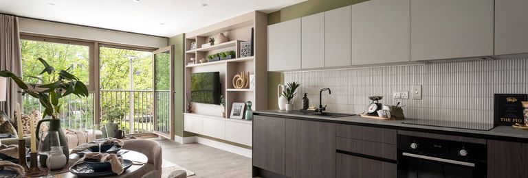 Property 1 of 5. Kitchen With Dining Table In Foreground, Decorated In Dark Tones, Living Space And Balcony Doors In