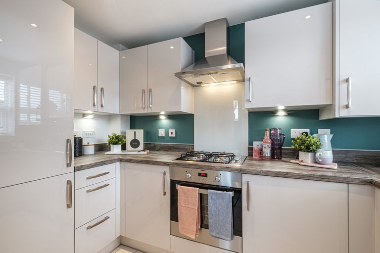Property 1 of 6. Kitchen With Green Feature Walls And Shiny White Cupboards