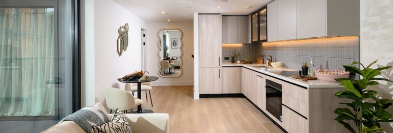 Property 2 of 5. Living Space With Glass Balcony Doors In Foreground, Kitchenette In Background