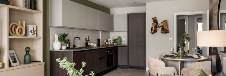 Property 2 of 5. Living Space In Foreground, Kitchen With Dining Table In Background, Decorated In Neutral Tones.