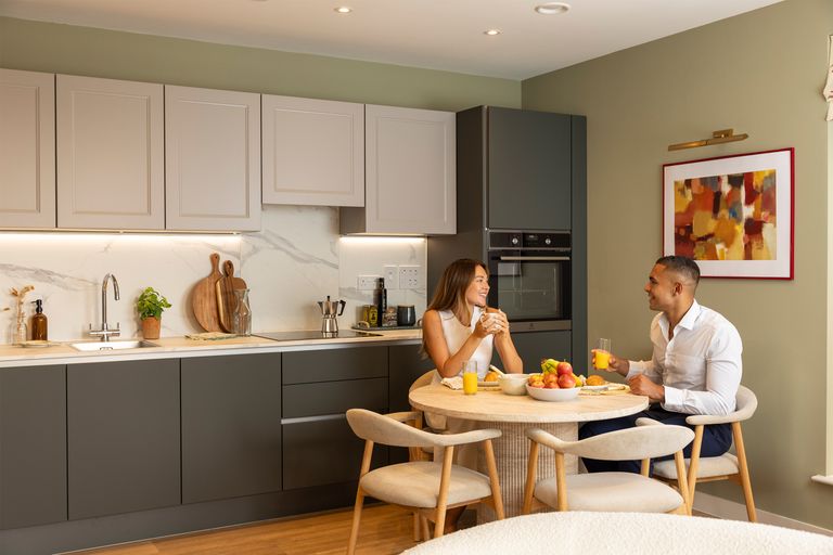 Property 2 of 6. Couple Sat At The Dining Table Next To The Kitchen Having Breakfast Together