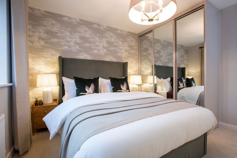 Property 3 of 7. A Cozy And Inviting Bedroom With A Large Bed, Mirrored Closet Doors