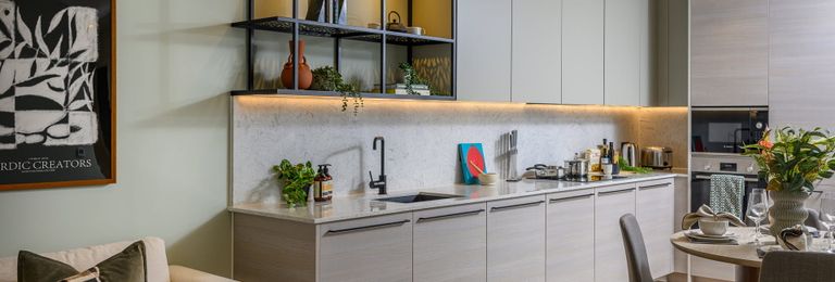 Property 2 of 5. Kitchenette With Modern Appliances, Beige Cupboard Panels And White Countertops, Dining Table