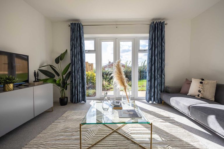 Property 3 of 5. A Cozy Living Room With A Glass Coffee Table, A Gray Sofa