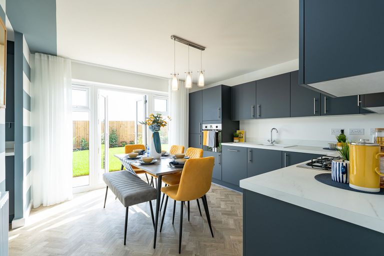 Property 3 of 10. A Modern And Stylish Kitchen With Gray Cabinets, A Dining Table With Yellow Chairs