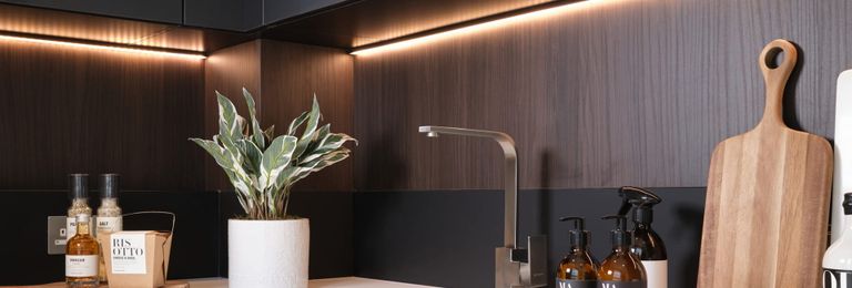 Property 3 of 5. Closeup Of Kitchen Countertops, Counter Decorations, Strip Lighting, Slate And Dark Wood Pattern